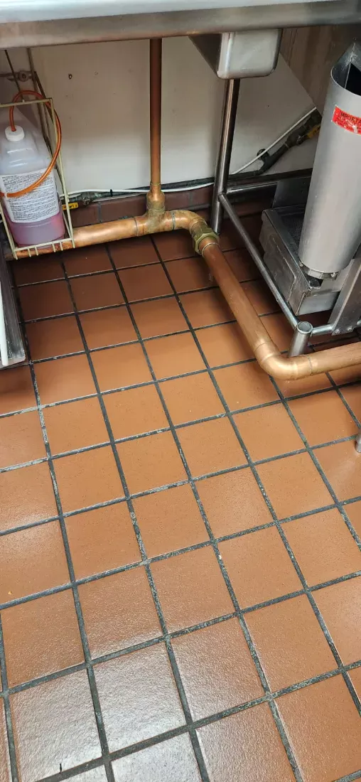 Commercial kitchen quarry tile floor degreased under the prep sink