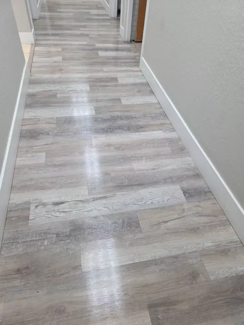 Office hallway vinyl plank floor mopped from end to end