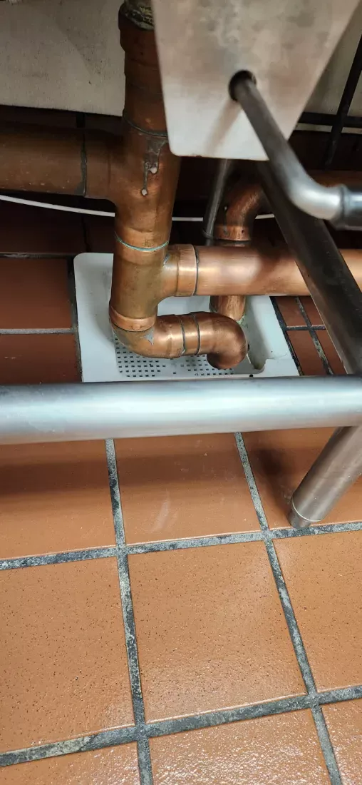 Kitchen floor drain and surrounding quarry tile cleaned around the pipework