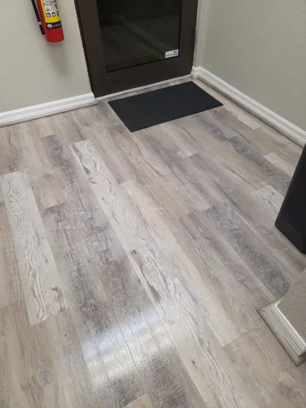 Entrance floor cleaned and the walk-off mat straightened at the glass door