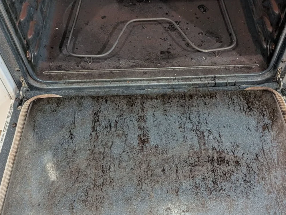 Oven caked with burnt-on grease before cleaning