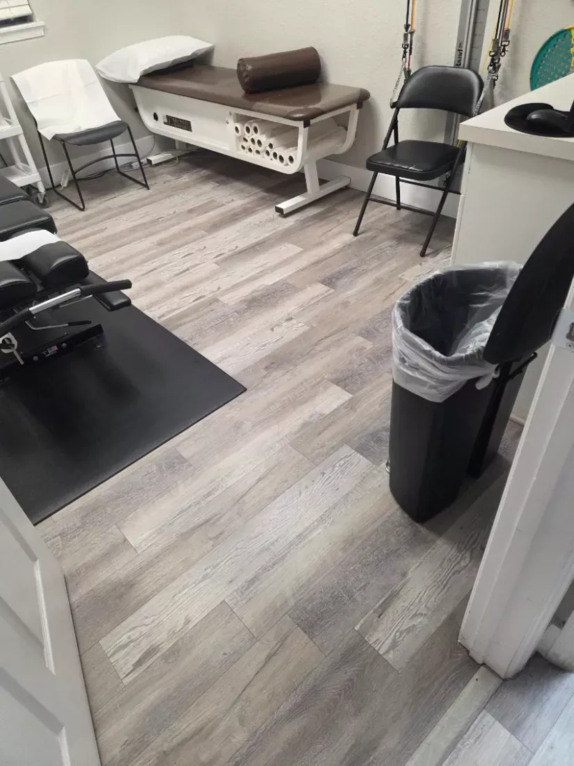 Clinic treatment room with the vinyl plank floor cleaned around the tables